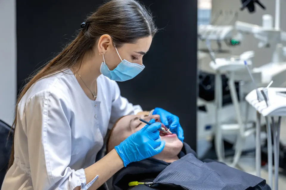 Adult smiling during crooked teeth consultation at Dental World Longwood