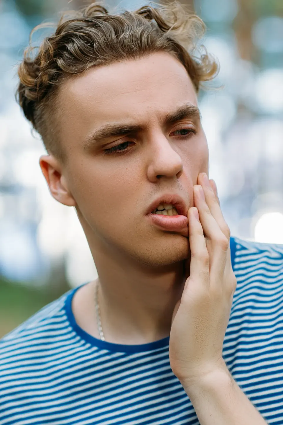 Person concerned about tooth sensitivity at Dental World Longwood