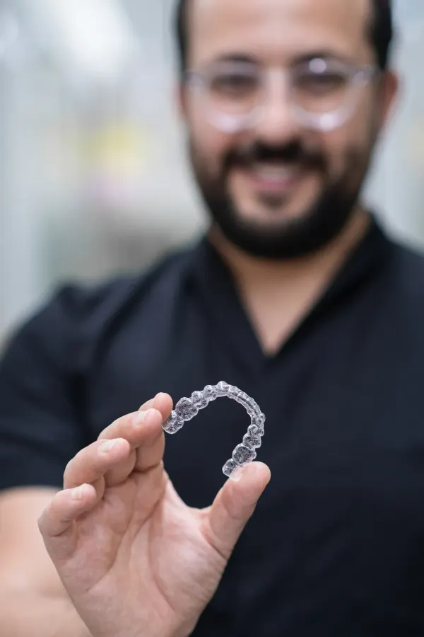 Before and after clear aligner results showing teeth straightening at Dental World Longwood