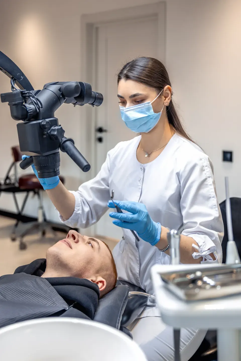 Patient and hygienist during dental cleaning consultation at Dental World Longwood